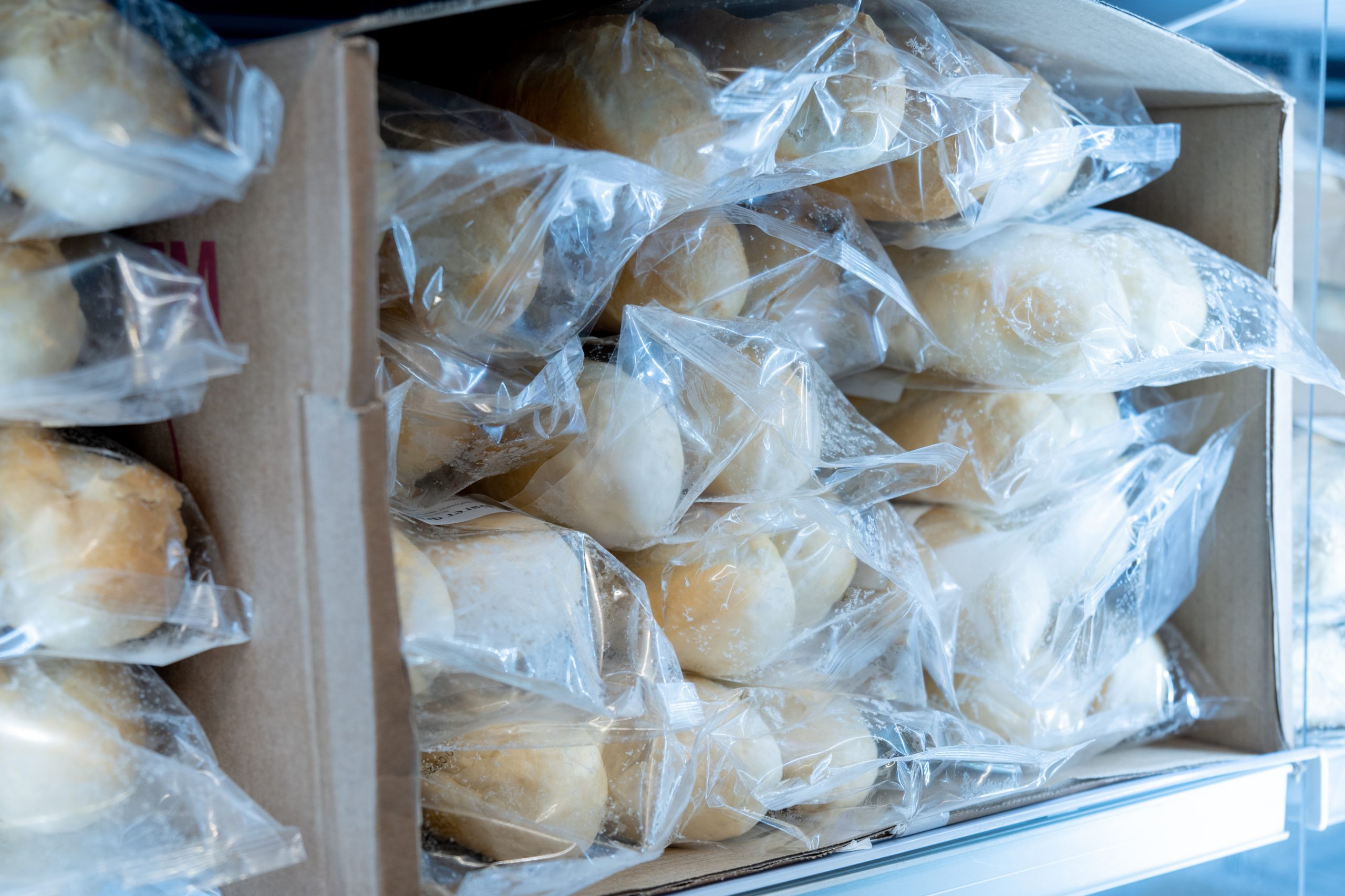 Frozen food on a shelf, big procurement and food storage in reserve. Frozen bread.