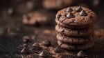 A stack of chocolate chip cookies with chocolate sprinkles on to
