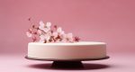 the camera shows a white cake standing next to spring flower