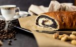 Yeast dough with cocoa filling surrounded by kitchen props text space