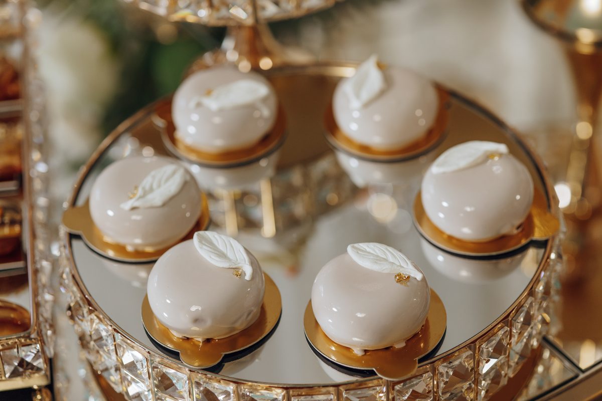 A tray of desserts with a leaf design on top