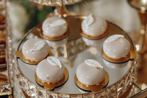 A tray of desserts with a leaf design on top