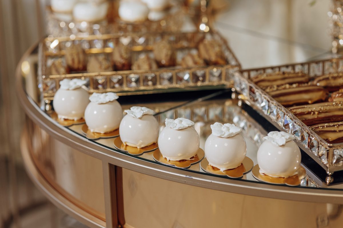 A table with a variety of desserts, including cakes and cookies