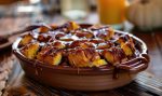A pumpkin bread pudding with a caramel drizzle served in a baking dish