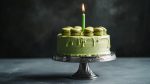 Celebrating with a green macaron cake topped with a candle