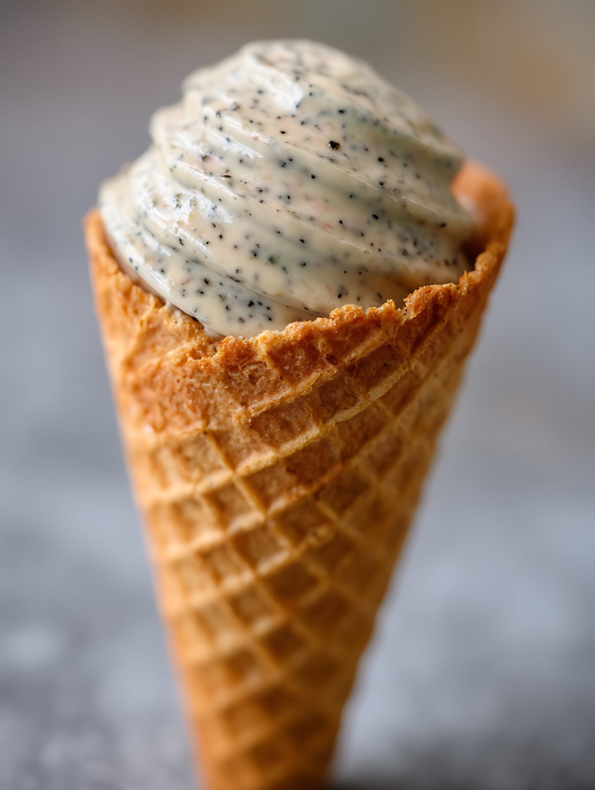 Close Up of Creamy Poppy Seed Ice Cream in a Waffle Cone.