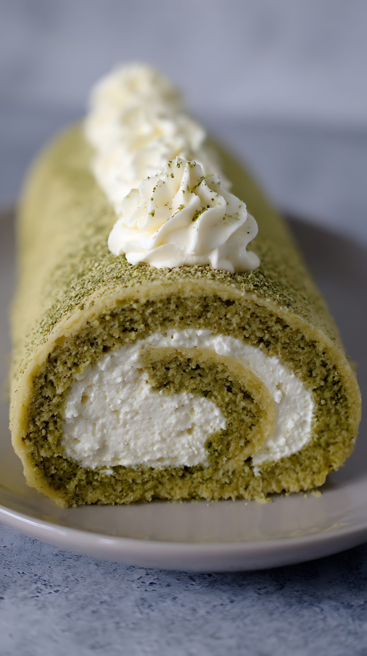 Delicious Matcha Swiss Roll Cake With Cream And Green Tea Powder.