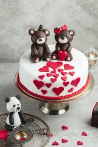 cake decorated with hearts and chocolate bears