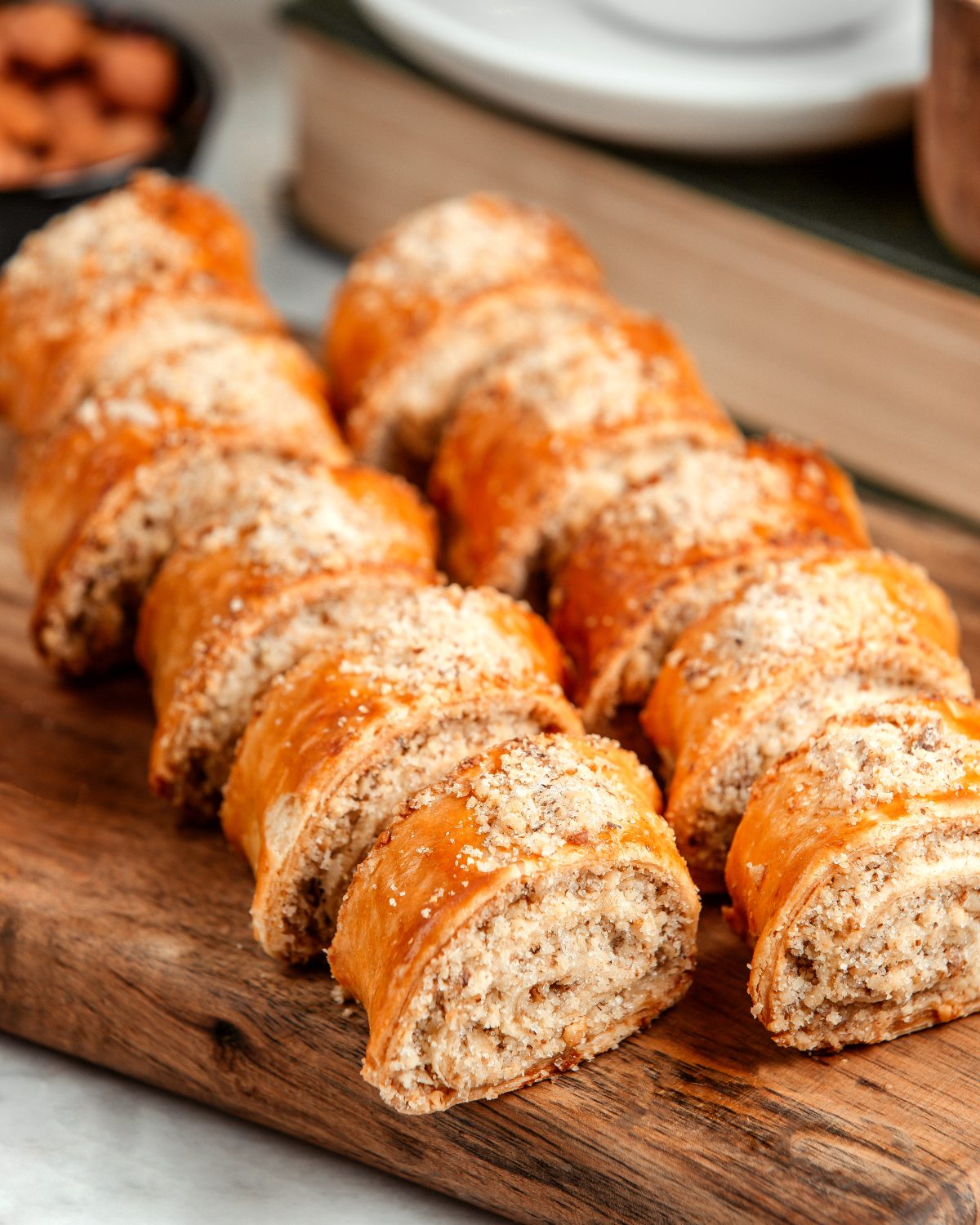 side view of pastry roll with nuts on wooden background