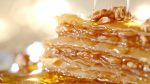 Golden baklava with dripping honey and nuts. Sweet treat for special occasion, holiday