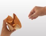 hand holding a brown paper bag