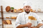 Young man working at his bakery