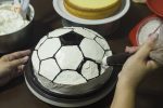 Lady making cake, football pattern decoration